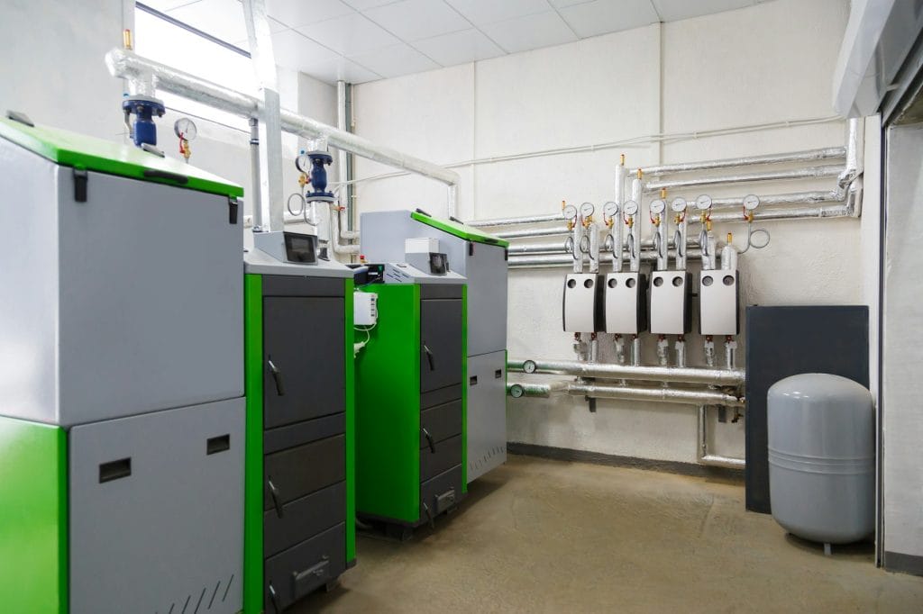 Large industrial boiler room with appliance using pallets as a fuel.